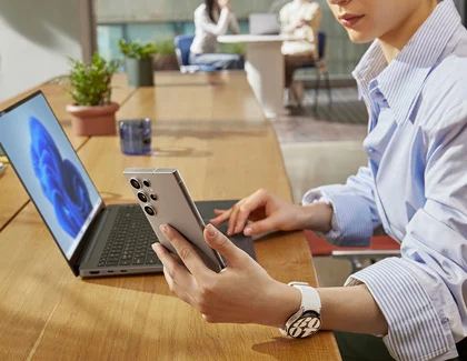 Person updating a Galaxy phone with Smart Switch on a laptop